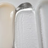 Un'immagine ravvicinata mostra le texture di Solawaves LightBoost Wand Activating Serum, con il beige cremoso, il gel trasparente infuso con la tecnologia LightBoost e la crema liscia grigio chiaro/bianco. Le texture variano da cremose a gel, ognuna delle quali presenta una finitura lucida.
